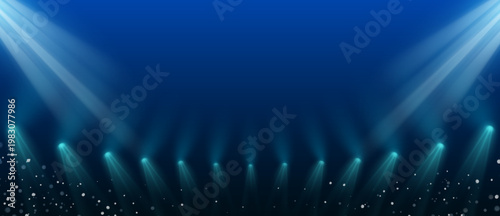 幻想的な青のグラデーション空間に広がるスポットライトと光粒が演出するライブステージ風背景イラスト素材