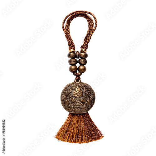 Ornate metallic charm with a braided cord handle and tassel on a black background