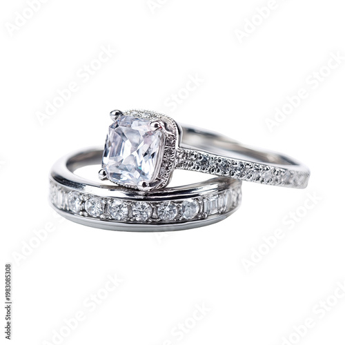 Two silver rings, one with a large diamond, set against a black background