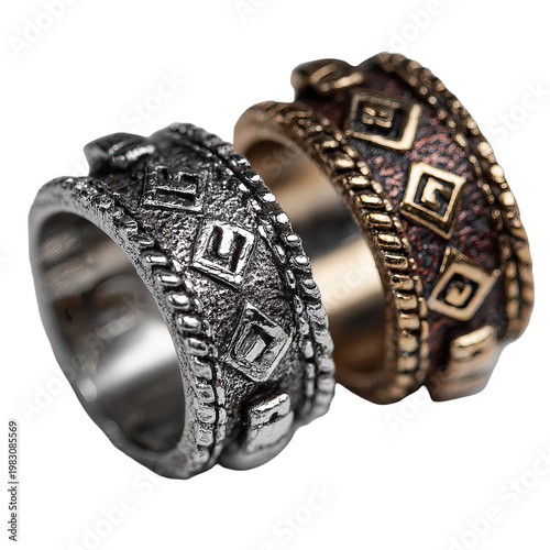Two intricately designed rings, one silver, one bronze, with geometric patterns