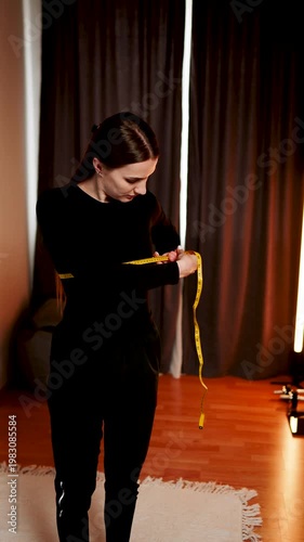 Woman measures body parts in front of mirror during personal fitness check