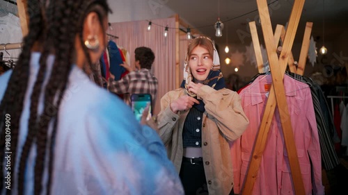 Spontaneous Scene Showcasing Cultural Friendship Amid Colorful Clothing And Warm Shop Lighting