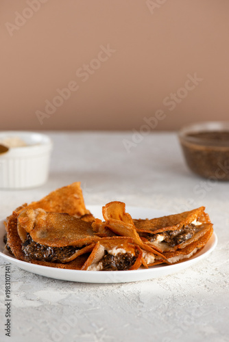 Vegan thin pancakes made from banana and green buckwheat flours with a filling of cashew ricotta and a plant-based caviar made from chia seeds and nori.
