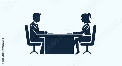 Business meeting between two professionals at a desk.