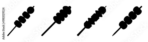 Set of grilled kebab skewers with charred meat and vegetables on white background