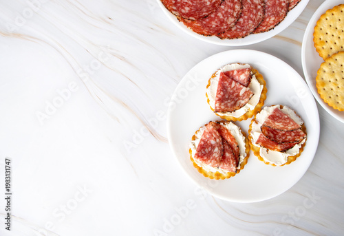 Salami and Cream Cheese Crackers Appetizer on a White Plate