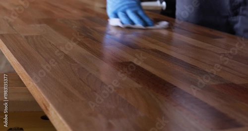 Laminated wood board finished with tung oil using piece of cloth, close up