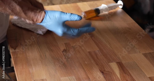 Woodworking art and craft, man put on protective rubber glove above laminated wood plate