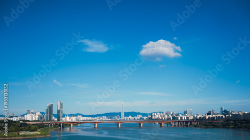 Photos Panoramic view of Seoul city skyline with Lotte World Tower and Seongsu bridge over Han River under clear blue sky