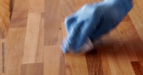 Laminated wood board finished with tung oil using piece of cloth, close up