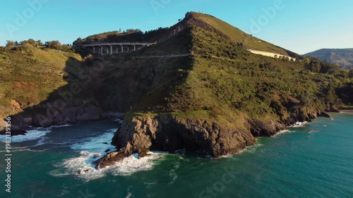 Aerial drone view of Cantabrian coastline with cliffs, green hills and ocean waves. Scenic coastal landscape in northern Spain, travel destination and nature scenery. High quality 4k footage