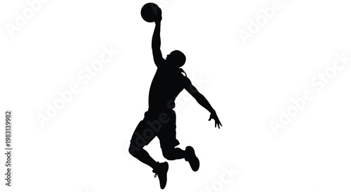 Silhouette of a basketball player in mid air preparing to shoot the ball