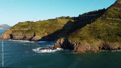 Aerial drone view of Cantabrian coastline with cliffs, green hills and ocean waves. Scenic coastal landscape in northern Spain, travel destination and nature scenery. High quality 4k footage