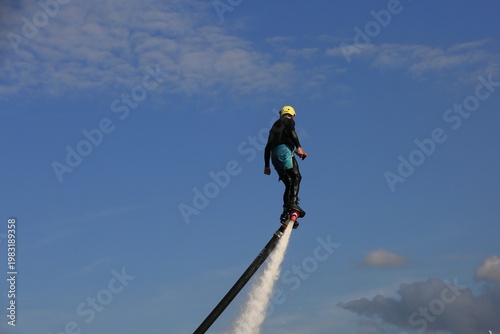 Flyboarding is an extreme water sport and entertainment that allows a person to float in the air above the water using a powerful water flow.