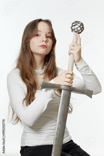 Portrait of a beautiful young princess girl with a sword