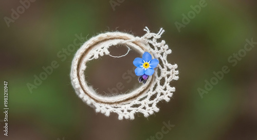Intricate Yarn Wreath with Small Blue Flower