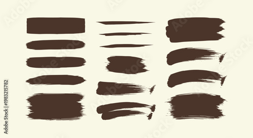 Collection of dark brown artistic paint brush strokes and ink texture smears on a cream background
