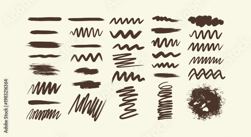 Set of dark brown hand-drawn ink brush strokes, zigzags and paint splatters on cream background.