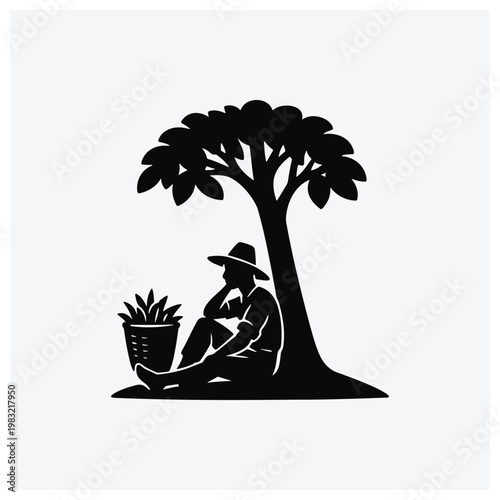 Silhouette of man sitting under tree with basket
