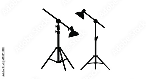 Two studio lights on stands depicted in a stark black silhouette