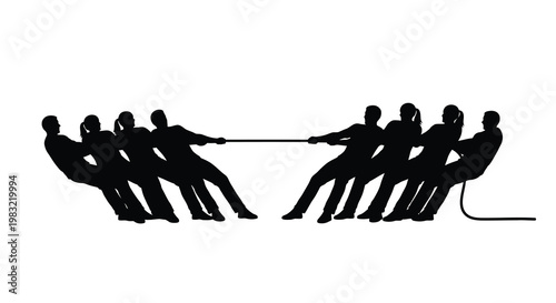 Silhouetted group engaged in a vigorous tug of war competition
