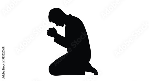 Silhouette of a man kneeling in prayer hands clasped together