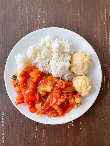 Top view of plate with balanced meal of cutlets, rice and stewed vegetables, healthy eating and nutrition