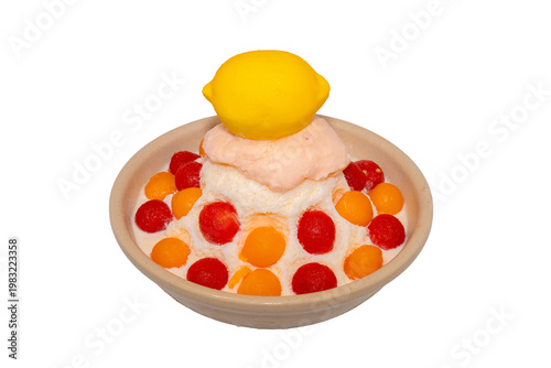 A refreshing bowl of fruit bingsu featuring shaved ice, melon and watermelon scoops, topped with a lemon-shaped dessert and Pocky.