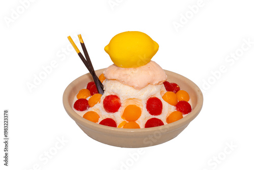 A refreshing bowl of fruit bingsu featuring shaved ice, melon and watermelon scoops, topped with a lemon-shaped dessert and Pocky.
