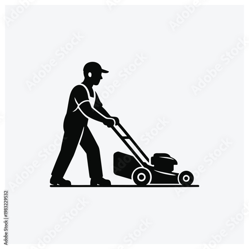 Silhouette of a man mowing the lawn with a push mower.