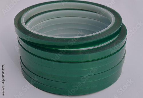 rolls of green adhesive tape neatly stacked for industrial, craft, or packaging applications.