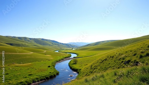 A serene valley with a gentle river winding through vibrant green meadows, framed by rolling hills under a clear blue sky,  tranquil,  mountains