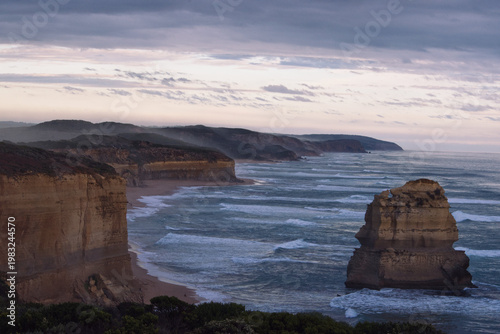 Sea spray over limestone coastline cliffs