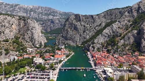 Aerial view of the historic town of Omis in Croatia, featuring the Cetina River canyon and dramatic limestone mountains