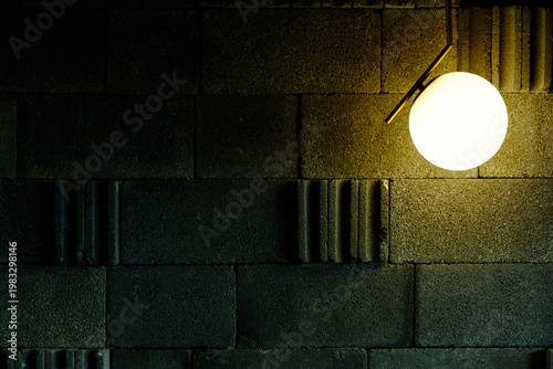 Fotografie Modern Globe Pendant Light on Textured Grey Concrete Brick Wall Background