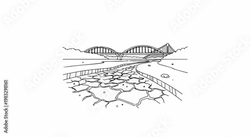 Cracked riverbed leads to a bridge with a serene backdrop