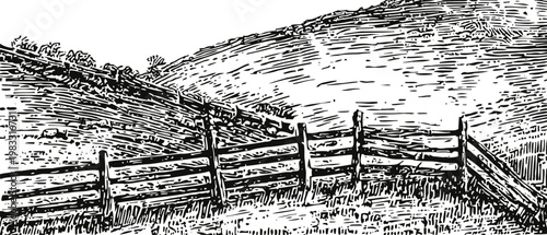 Rustic wooden fence on hillside landscape hill slope with grass and fence posts