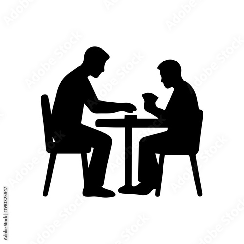Two men playing cards at a table silhouette