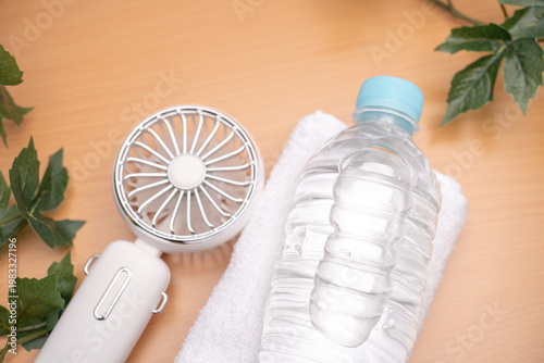 Personal cooling items with fan towel and water for hot weather