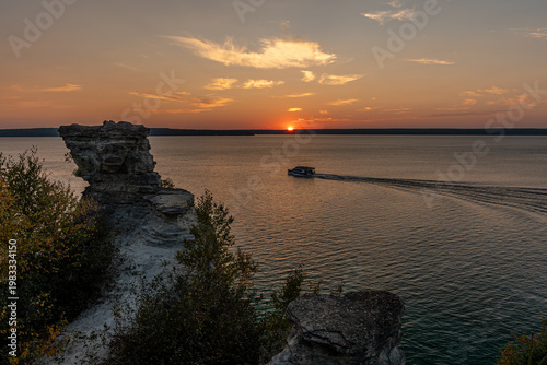 Sunset at Miner's Castle, Pictured Rocks National Lakeshore, Lake Superior boat trail, orange sky over rocky cliffs, Michigan USA.
