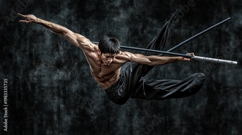 Male martial artist performing a dynamic pose with weapons