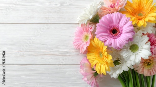 White wooden background with a vibrant bouquet of flowers