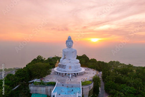 Фотография A magnificent white marble Buddha statue sits serenely atop a lush Phuket hillto