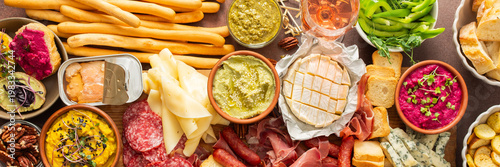 Quadro em tela This festive spread features an array of cheese, cured meats, hummus, nuts, and fresh vegetables