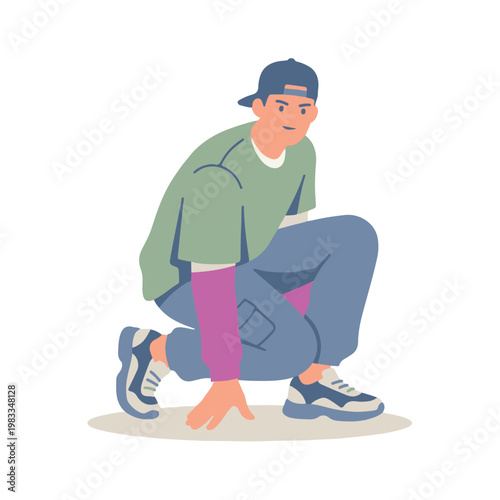 A young man wearing a cap crouches on the ground in a casual pose.