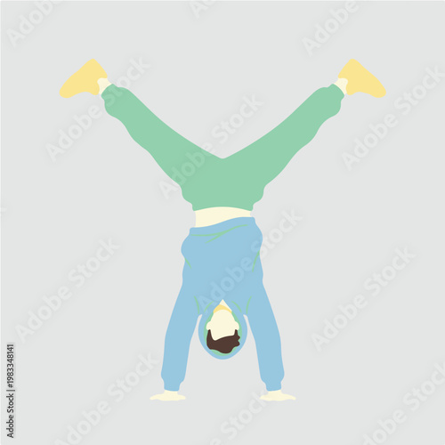 Person performing a handstand with legs spread wide.