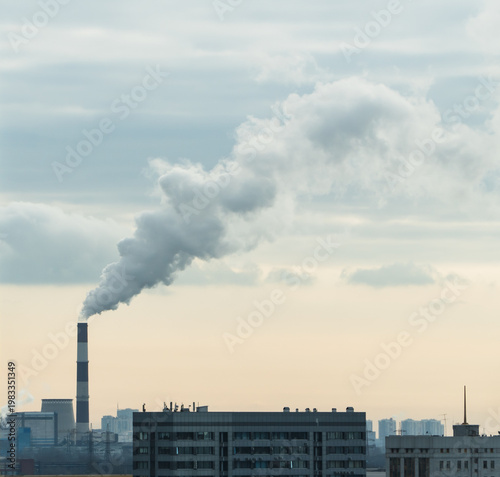 Factory chimney fumes emitting pollution to the atmosphere. CO2 and greenhouse gases emissions. The chimney emits exhaust gases into the sunset sky. The concept of air pollution and the environment.	