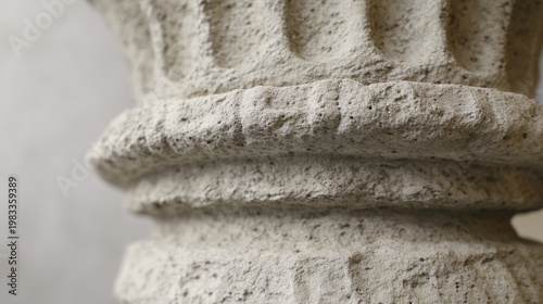 Minimalist architectural column detail in concrete with dramatic side lighting and monochrome tones. real-estate listings.