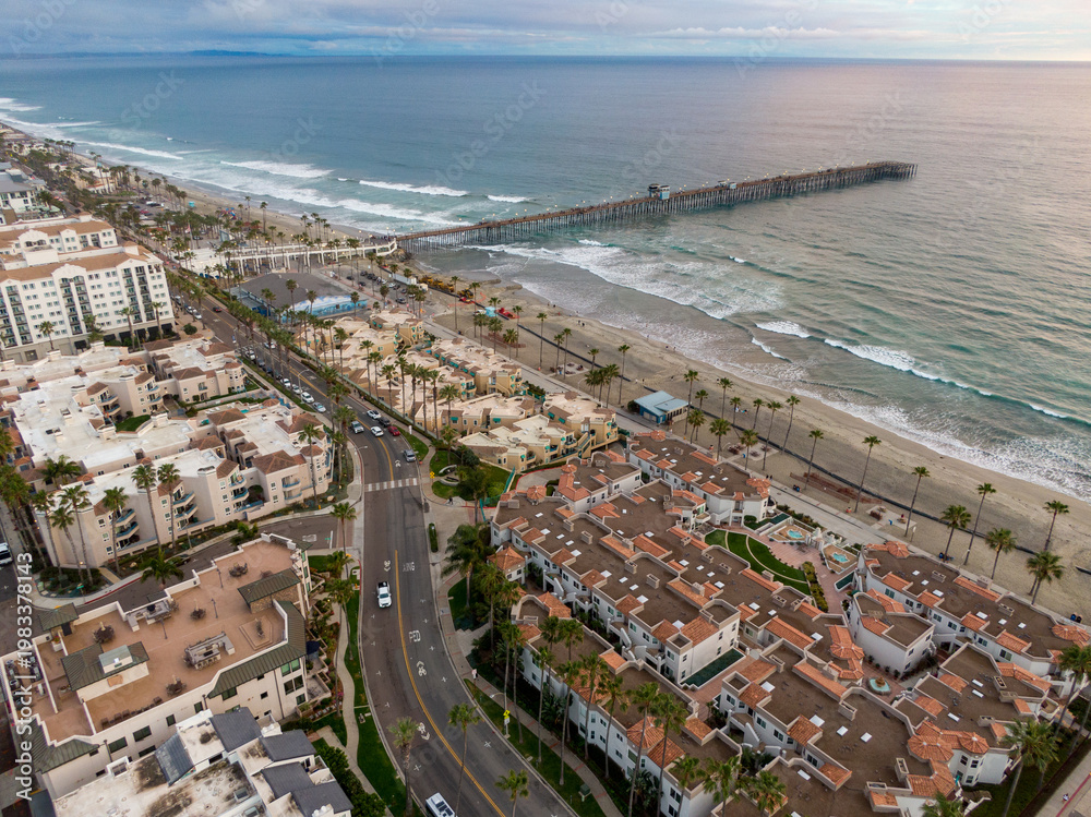 Fototapeta premium Oceanside California Beachfront Residential Rooftops And Sandy Coastline Aerial