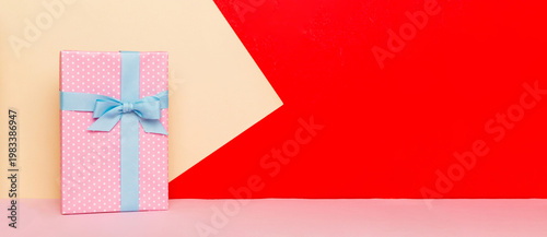 holiday handmade paper present tied blue ribbon bow top view with copy space. Flat lay holiday background. Birthday or christmas present. Christmas gift box concept with copy space